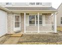 Inviting front porch with classic railings, offering a cozy outdoor seating area and a welcoming entrance at 1229 Tealpoint Cir, Indianapolis, IN 46229