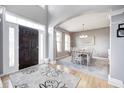 Inviting entryway with hardwood floors, an elegant rug, and an archway leading to the dining room at 1295 Longleaf St, Avon, IN 46123