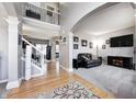 Open-concept living room with hardwood floors, staircase, neutral paint, and comfortable seating at 1295 Longleaf St, Avon, IN 46123