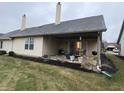 Home featuring a covered patio overlooking the well-maintained backyard at 1348 Mccormicks Cir, Danville, IN 46122