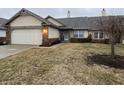 Charming home featuring an attached garage, brick accents and well maintained landscaping at 1348 Mccormicks Cir, Danville, IN 46122