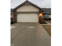 Attached two car garage and driveway of a charming well maintained home at 1348 Mccormicks Cir, Danville, IN 46122