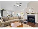 Spacious living room featuring a cozy fireplace and sectional sofa at 1402 W Limestone Way, Fortville, IN 46040