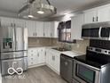 Modern kitchen with stainless steel appliances and white cabinets at 1519 Mary Dr, Lebanon, IN 46052