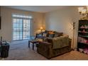 Living room with brown couch, coffee table, and bookcase at 15314 Mystic Rock Dr, Carmel, IN 46033