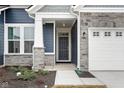 Front entry with stone pillars and dark-stained door at 16930 Cole Evans Dr, Noblesville, IN 46060