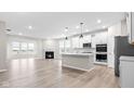 Open concept kitchen with white cabinets and island at 16930 Cole Evans Dr, Noblesville, IN 46060