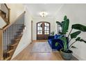 Bright foyer features hardwood floors, staircase, and a view of the front door at 236 Chatham Hills Blvd, Westfield, IN 46074