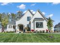 Beautiful two-story home with a brick facade, double door entryway, and manicured lawn at 236 Chatham Hills Blvd, Westfield, IN 46074