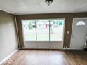 Bright living room featuring hardwood floors and large windows at 2704 Seminole Dr, Anderson, IN 46012