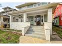 Charming front porch with white pillars, space for seating, and a view of the front yard at 3356 N Park Ave, Indianapolis, IN 46205