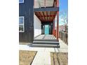 Modern front entrance with teal door, gray composite deck, and black railings at 337 N Beville Ave, Indianapolis, IN 46201