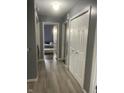 Bright hallway with light wood flooring and doors to bedrooms at 37 Medina Ln, Indianapolis, IN 46227
