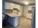 Galley kitchen with white cabinets and L-shaped counter at 37 Medina Ln, Indianapolis, IN 46227