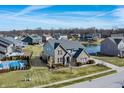 Aerial view of a suburban home featuring a pool, well-kept yard, and scenic water views at 377 Morningside Dr, Brownsburg, IN 46112