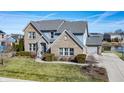 Two-story home with brick and stone accents, a manicured lawn, and an attached garage at 377 Morningside Dr, Brownsburg, IN 46112