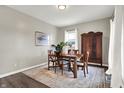 A well-lit dining room with hardwood floors, a wooden table, and antique storage at 5704 E 16Th St, Indianapolis, IN 46218