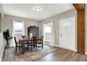 Bright dining room featuring a wood table, antique cabinet, and hardwood floors at 5704 E 16Th St, Indianapolis, IN 46218