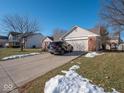 View of the attached garage and driveway at 6264 Whitaker Farms Dr, Indianapolis, IN 46237