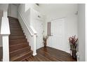 Inviting entryway with wood floors, staircase, and natural light creating a warm and welcoming ambiance at 6623 Pasco Ln, Plainfield, IN 46168