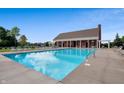 Inviting community pool with brick pool house and lounge chairs at 6871 Oakdale Ln, Avon, IN 46123