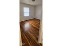 Bright bedroom featuring hardwood floors and a large window at 733 S Emerson Ave, Indianapolis, IN 46203