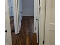 Hardwood floors and white doors in the hallway at 733 S Emerson Ave, Indianapolis, IN 46203