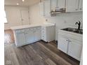 White kitchen with light gray vinyl flooring and stainless steel appliances at 733 S Emerson Ave, Indianapolis, IN 46203