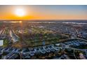 Breathtaking aerial view of a neighborhood with beautiful homes, green spaces, and serene lakes under a golden sunset at 9812 Ridgecrest Ln, McCordsville, IN 46055
