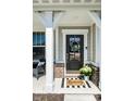 Cozy front porch featuring a welcome mat, and plants that highlight the home's charming entrance at 11034 Saddlebred Dr, Indianapolis, IN 46239