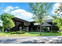 Beautifully landscaped exterior showcasing lush lawn and mature trees surrounding the dark-painted home at 11710 Cold Creek Ct, Zionsville, IN 46077