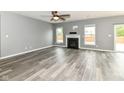 Spacious living room features hardwood floors, a modern fireplace and two windows for ample natural light at 1324 Trailside Dr, Greenwood, IN 46143