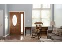 Inviting entryway with hardwood floors and rocking chair at 1642 Foxmere Blvd, Greenwood, IN 46142