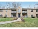 Charming condo building with a brick facade, balconies, and a neatly landscaped yard at 1737 E 56Th St # B, Indianapolis, IN 46220