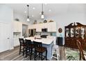 Modern kitchen with a spacious island, stainless steel appliances, and a view into a bright dining area at 18775 Brookston Ln, Noblesville, IN 46062