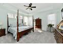 Serene bedroom with a four-poster bed, soft colors, and abundant natural light from large windows at 18775 Brookston Ln, Noblesville, IN 46062