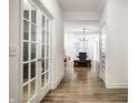 Hallway view with light-colored wood floors, white walls, and a glimpse of the dining area at 2242 Egbert Rd, Westfield, IN 46074