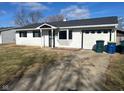 White ranch house with black roof, landscaping, and attached garage at 2708 E 26Th St, Muncie, IN 47302