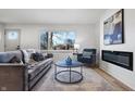 Bright living room featuring hardwood floors, fireplace, and comfy seating at 3052 S Fielding Rd, New Palestine, IN 46163