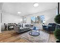 Light-filled living area with hardwood floors and a cozy seating arrangement at 3052 S Fielding Rd, New Palestine, IN 46163