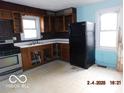 Corner kitchen with wooden cabinets and appliances at 3531 Brown St, Anderson, IN 46013