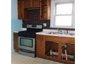 Basic kitchen with wooden cabinets and appliances at 3531 Brown St, Anderson, IN 46013