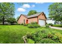 Well-maintained home exterior with a lush front lawn and garden beds at 4646 Rocky Knob Ln, Indianapolis, IN 46254