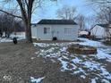 Backyard with firepit and partial snow coverage at 5209 Laredo St, Indianapolis, IN 46237