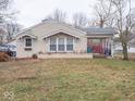 Tan brick ranch house with covered porch and front yard at 6004 S Orinoco Ave, Indianapolis, IN 46227