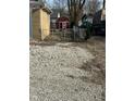 Large gravel backyard with storage shed and gated entrance at 6107 Hazelhatch Dr, Indianapolis, IN 46228