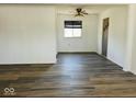 Bright dining room featuring hardwood floors and a ceiling fan at 6107 Hazelhatch Dr, Indianapolis, IN 46228