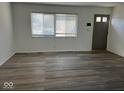 Spacious living room with hardwood floors and large window at 6107 Hazelhatch Dr, Indianapolis, IN 46228