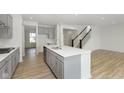 Modern kitchen with gray cabinets, island, and stainless steel appliances at 6322 Stone Side Dr, Plainfield, IN 46168