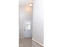 Neutral entryway with gray tile flooring, white walls, and white door featuring glass window panes at 6617 Reserve Dr, Indianapolis, IN 46220